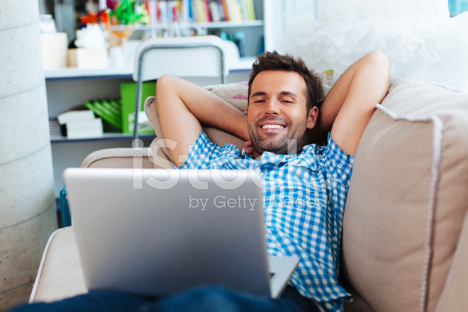 29627320-man-relaxing-with-laptop-on-couch.jpeg